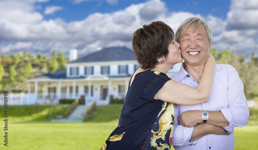 Affectionate Senior Chinese Couple In Front of Beautiful House Affectionate Senior Chinese Couple In Front of Beautiful House
