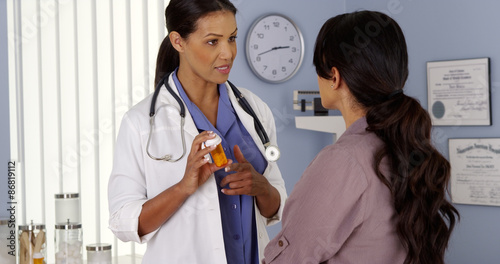 African American physician talking to hispanic patient about medicine photo