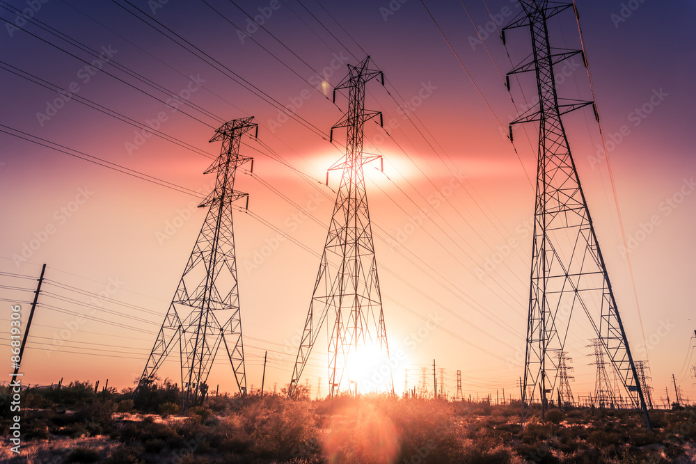 Electricity supply towers as sun sets