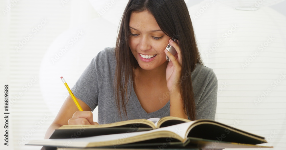 Hispanic woman calling friend for help with homework