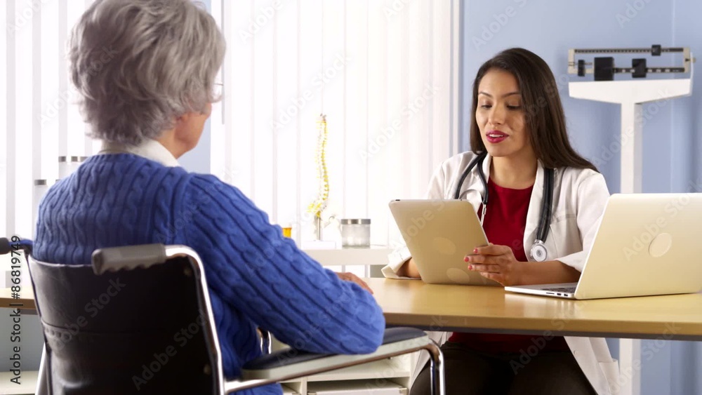 Young Mexican doctor talking with elderly patient Young Mexican doctor talking with elderly patient