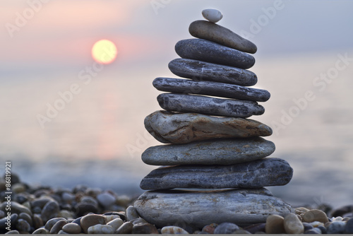 Leinwand Poster Stack of pebbles on beach. Natural background
