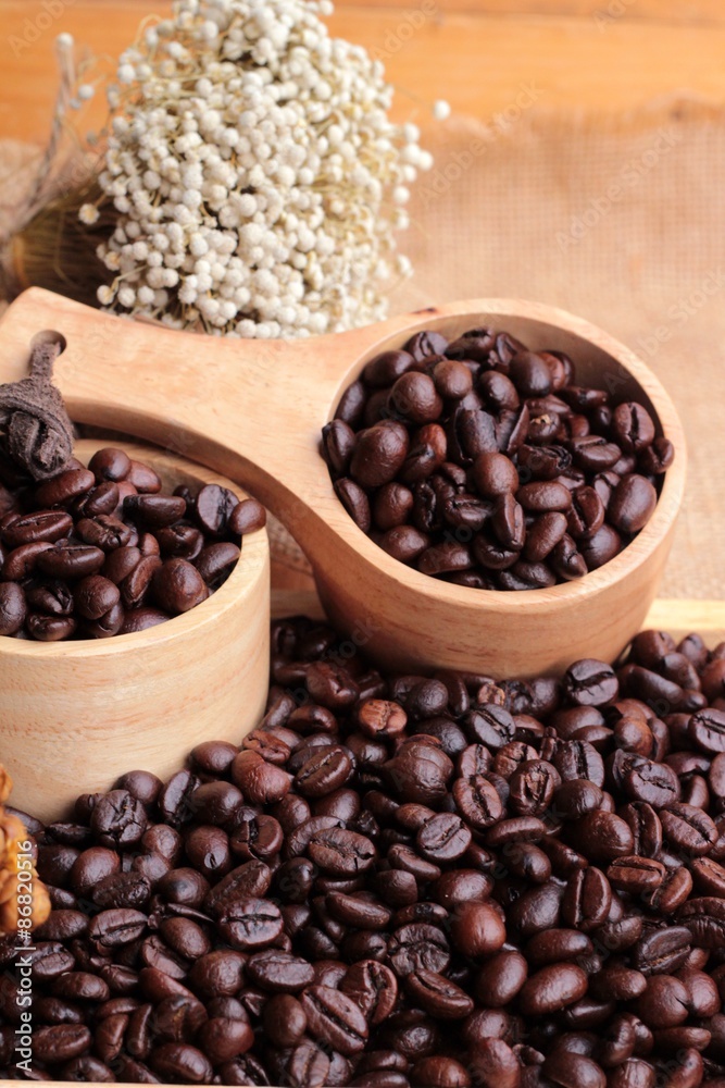 Roasted coffee beans on sack brown background. Roasted coffee beans on sack brown background.