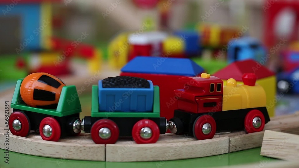 a little boy playing with a toy train