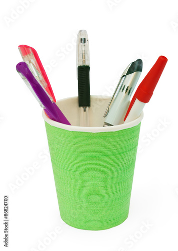 different pens in a green plastic cup
