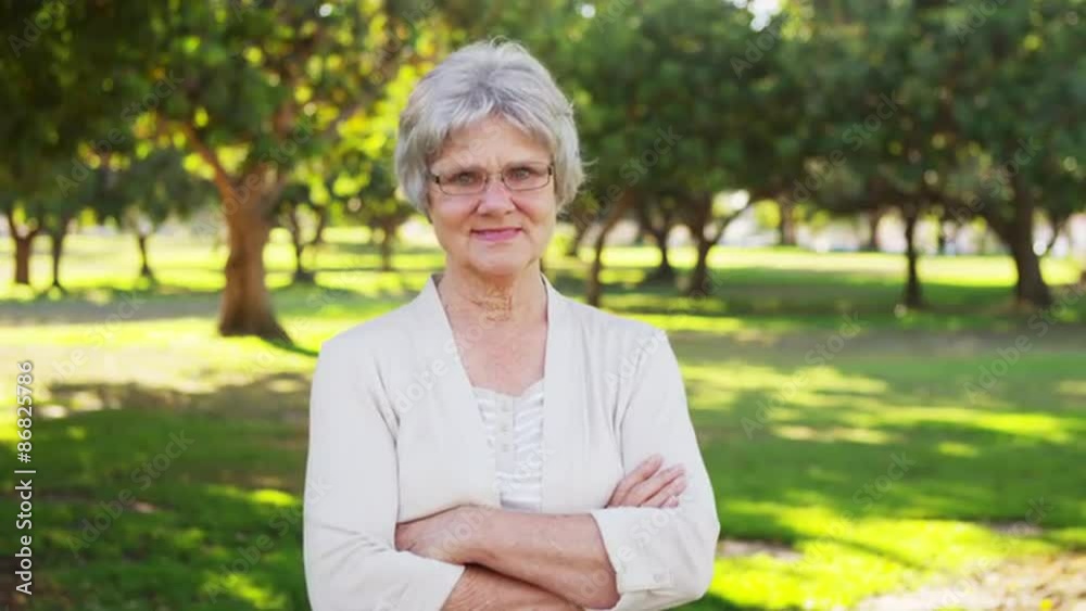 Happy senior woman standing in the park Happy senior woman standing in the park