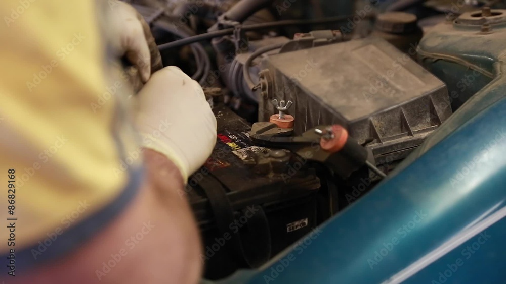 auto mechanic replacing battery in car auto mechanic replacing battery in car