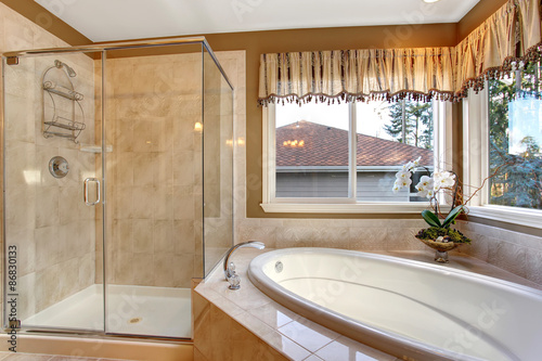 Large elegant master bathroom with tile floors  and glass shower