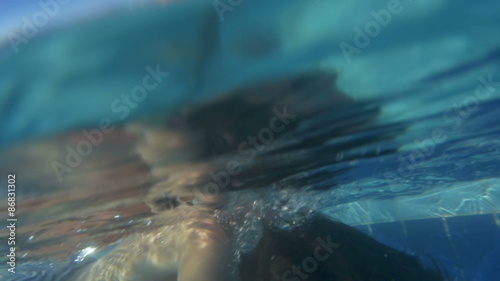 Father and son playing in the swimming pool