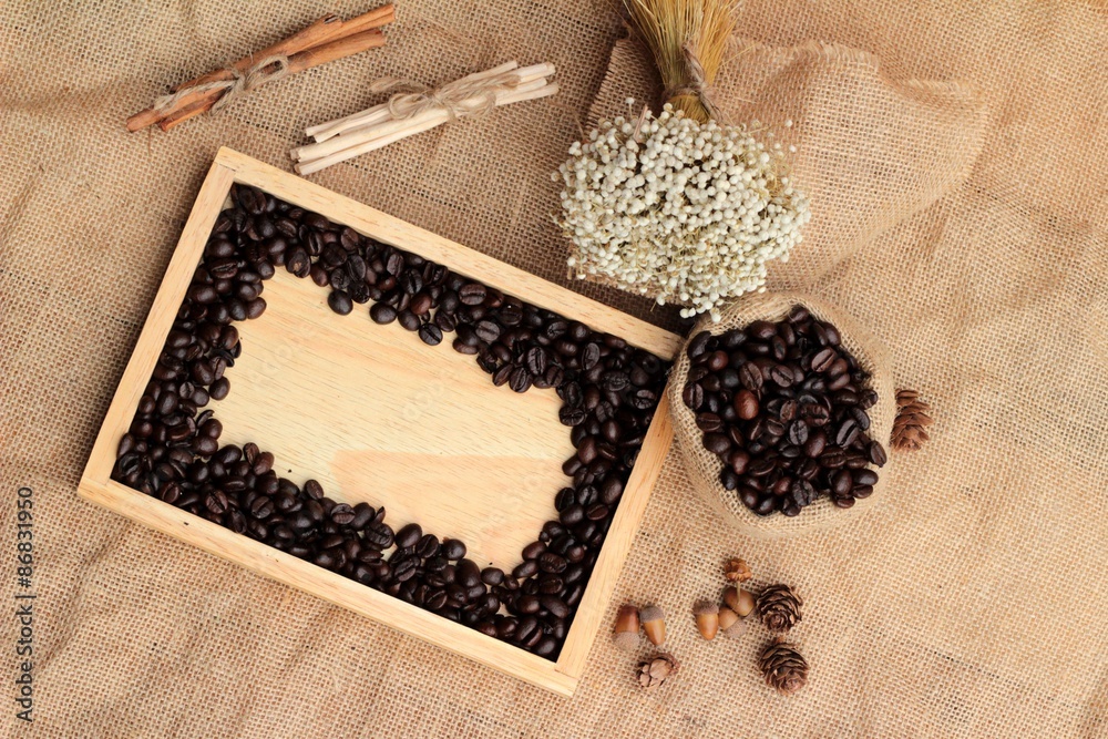 Roasted coffee beans on sack brown background. Roasted coffee beans on sack brown background.