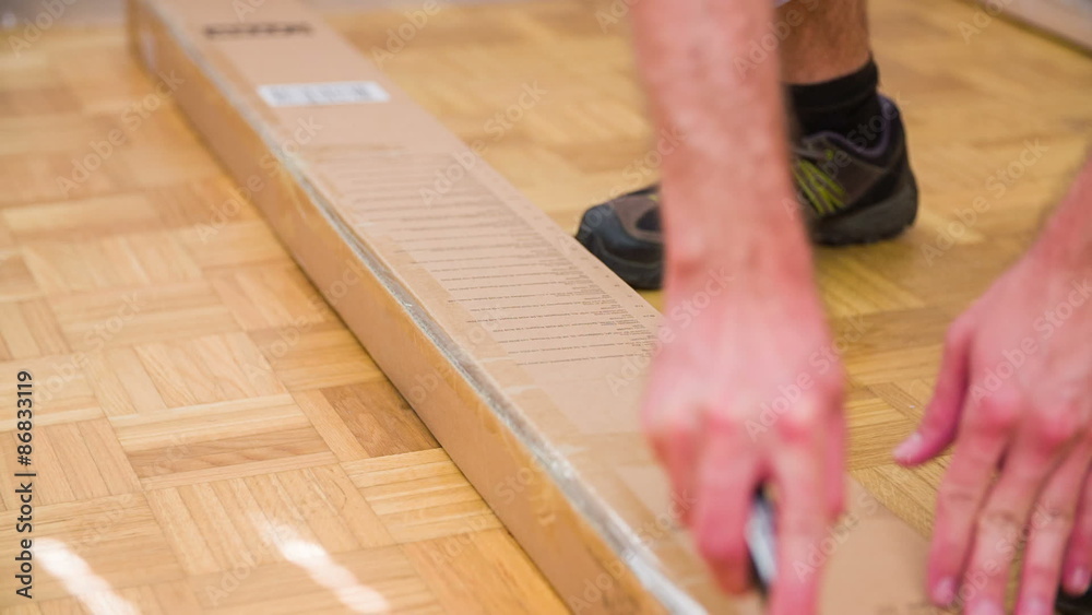 Cutting long box with knife close up Cutting long box with knife close up