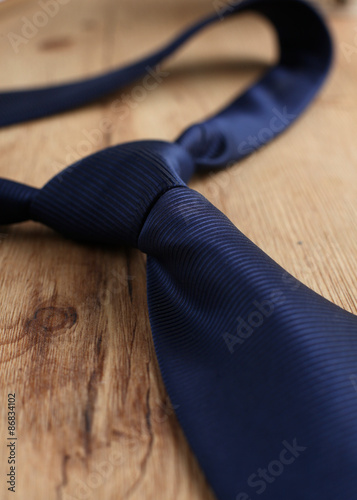 Elegant blue tie on a wooden background 