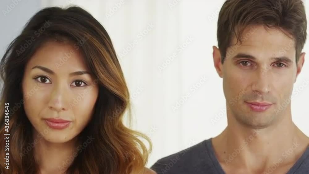 Attractive interracial couple looking at camera Attractive interracial couple looking at camera