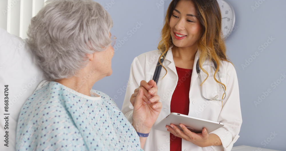 Asian doctor holding hand of elderly woman patient in hospital Asian doctor holding hand of elderly woman patient in hospital