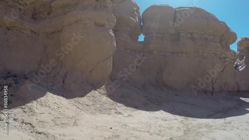 Boy running around in goblin valley state park rock formations photo