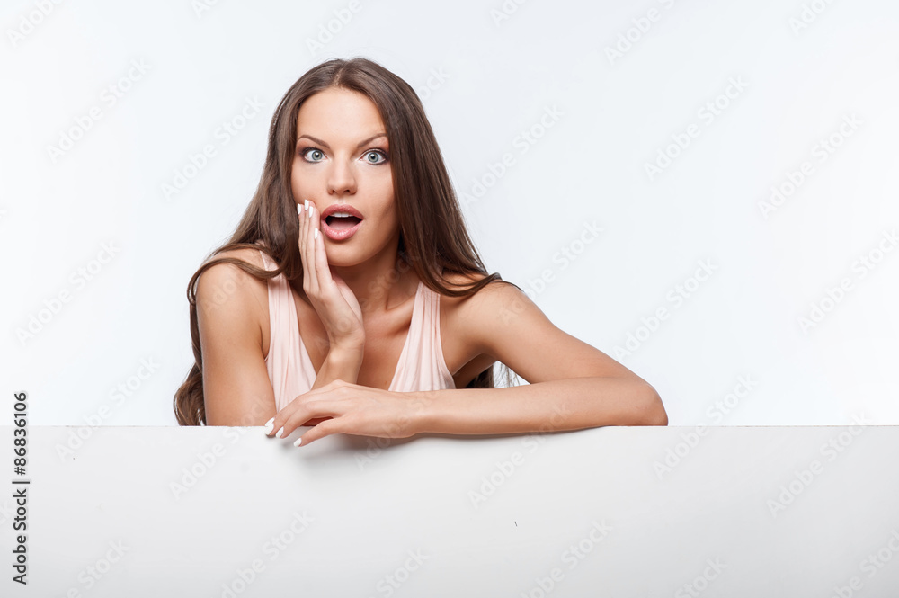 Pretty young girl is standing near horizontal surface Pretty young girl is standing near horizontal surface