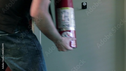 Man grabs and then replaces fire extinguisher