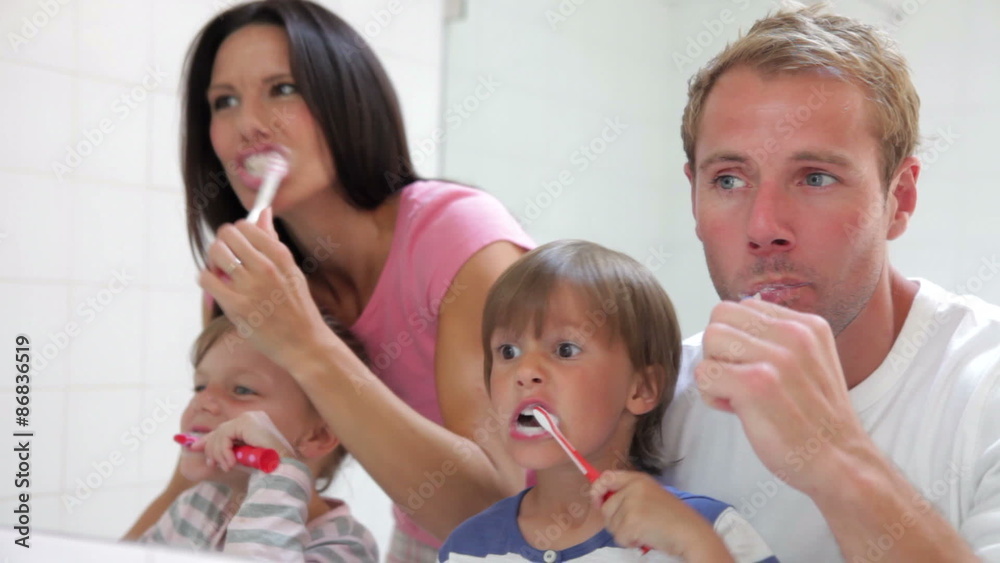 Family Reflected In Bathroom Mirror Brushing Teeth Family Reflected In Bathroom Mirror Brushing Teeth