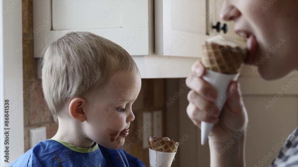 Mother eating an ice cream with toddler Mother eating an ice cream with toddler