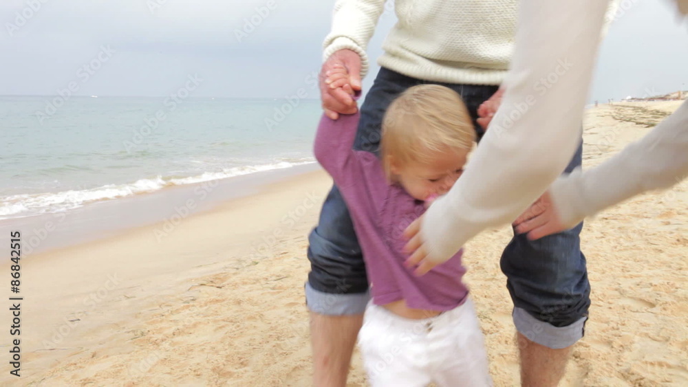 Grandparents And Granddaughter Walking Along Beach Together Grandparents And Granddaughter Walking Along Beach Together