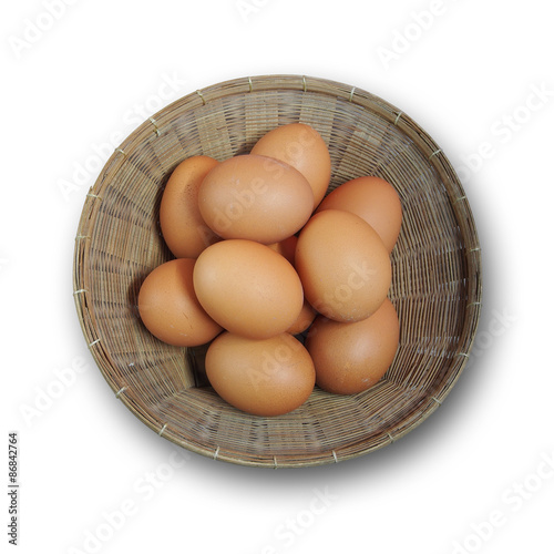 Fresh eggs in basket isolated on white background