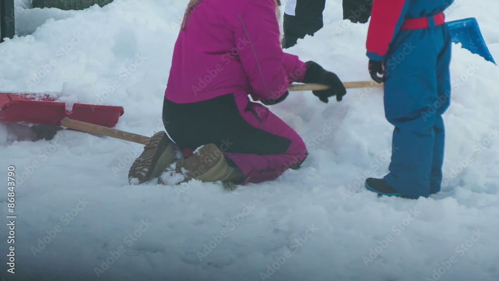 Kids playing in snow close up on legs