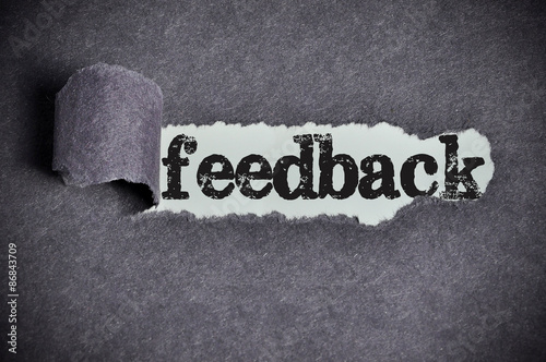 feedback word under torn black sugar paper