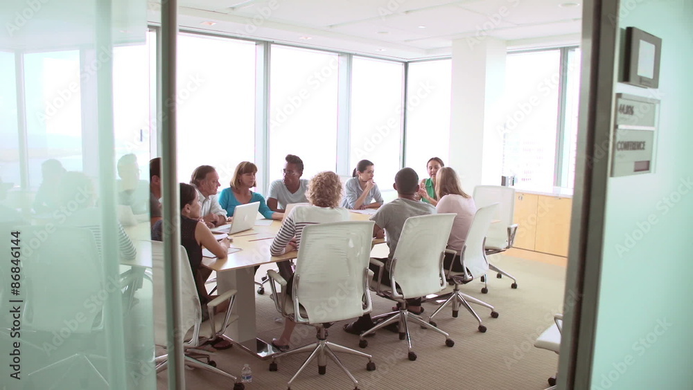 Group Of Businesspeople Meeting Around Boardroom Table Group Of Businesspeople Meeting Around Boardroom Table
