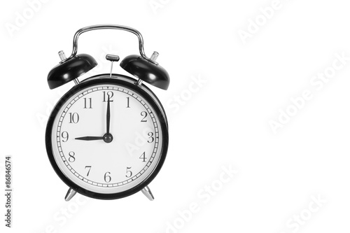 Nine O' Clock on alarm clock isolated on white