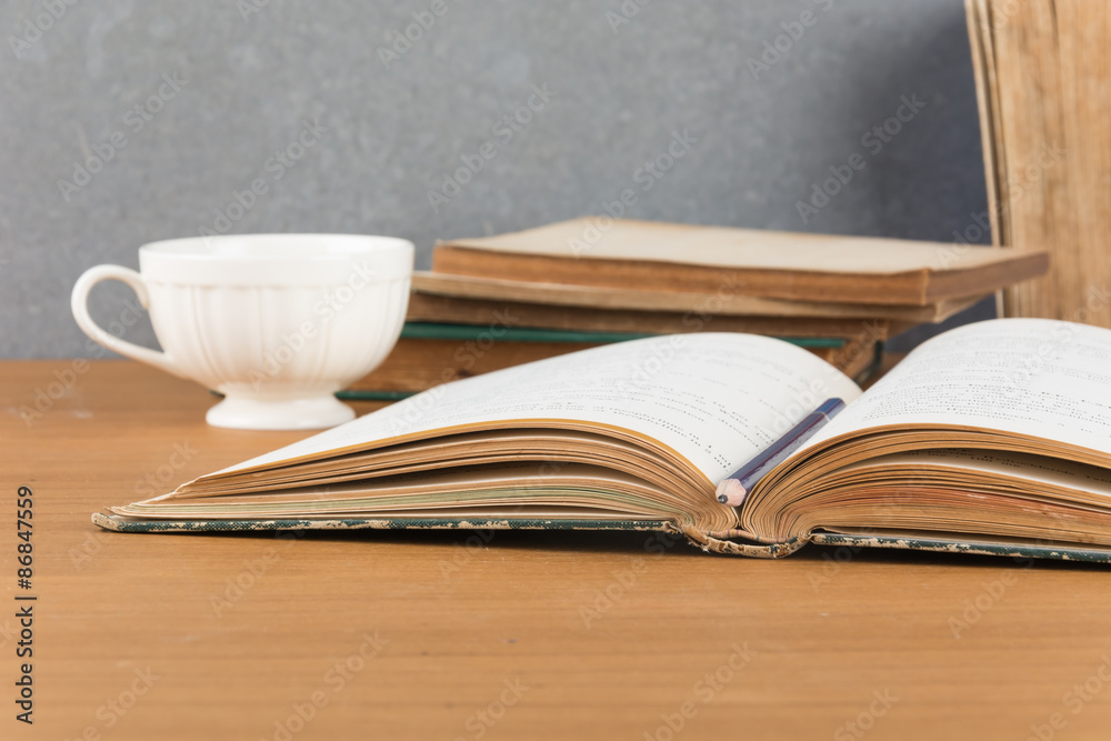 old book with pencil and coffee old book with pencil and coffee