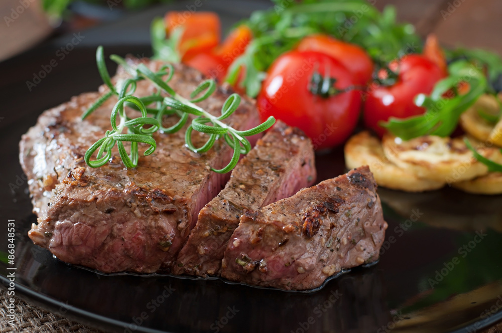 Closeup of grilled beef steak with vegetables