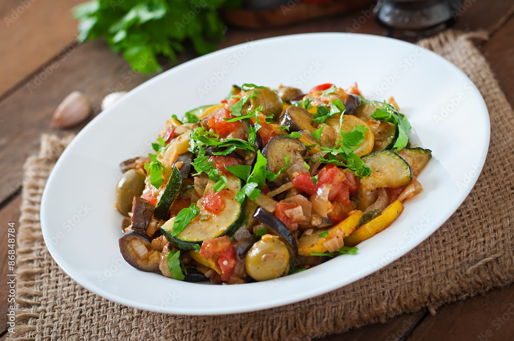 Vegetable Ratatouille in white plate on a wooden table