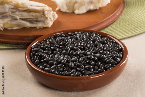 Black beans on wooden background © paulovilela