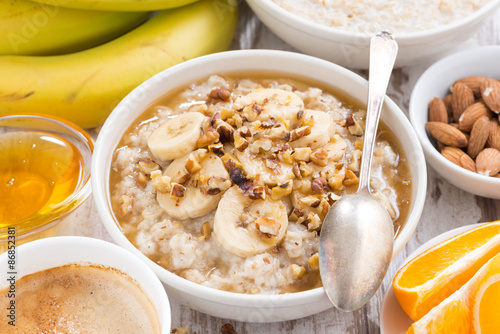 healthy breakfast - oatmeal with banana, honey and walnuts 