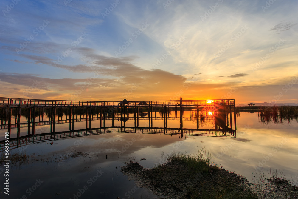 Wooden Bridge in lotus lake on sunset time at Khao Sam Roi Yot National Park, Thailand