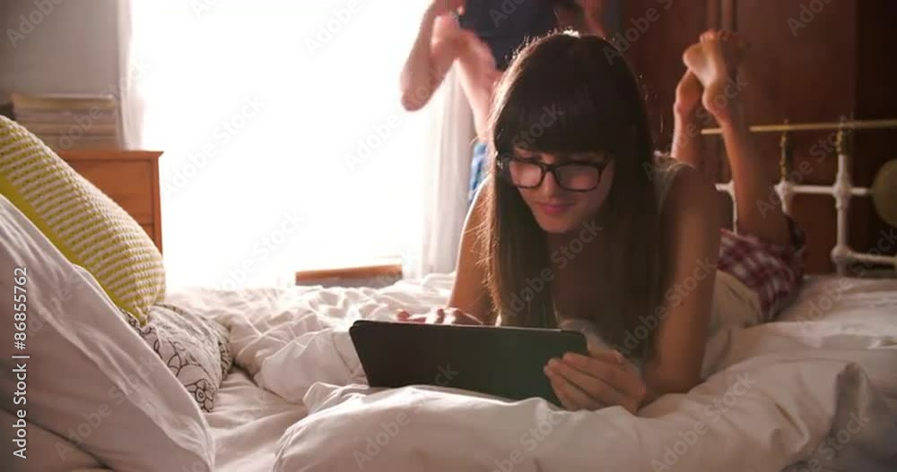 Man Getting Dressed As Woman Uses Digital Tablet In Bedroom