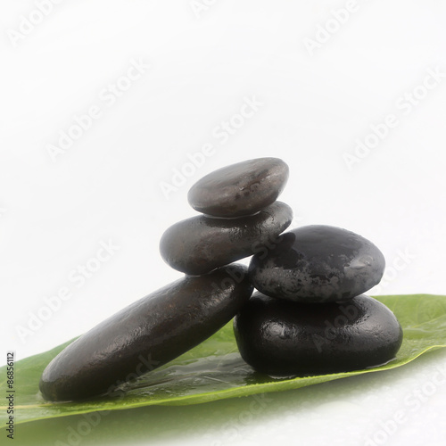 Balanced black zen stones on white background  
