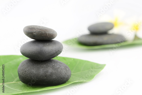 Balanced black zen stones on white background  