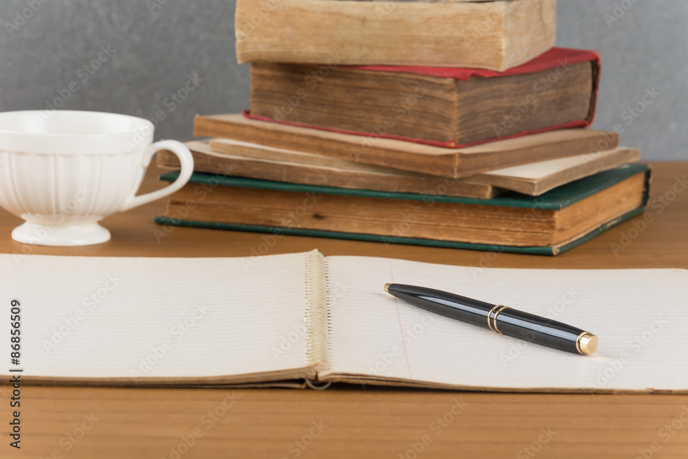 old notebook with pen on wood table old notebook with pen on wood table
