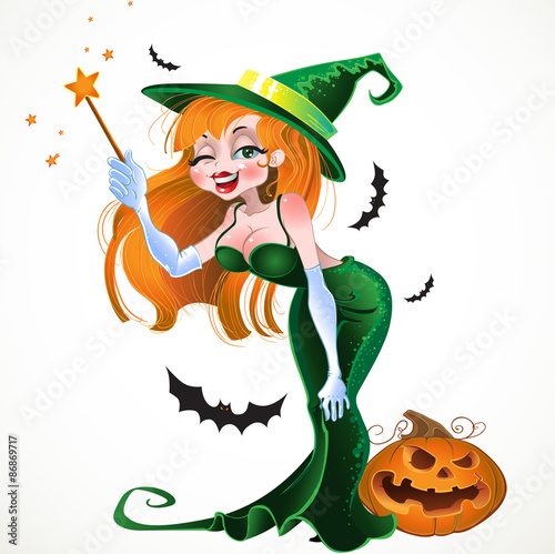 Cute sexy witch in green dress with the magic wand and pumpkin