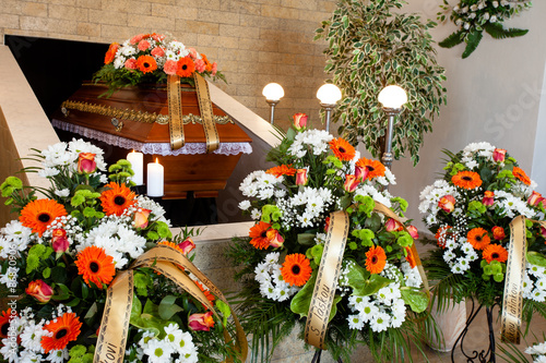 Funeral hall with wooden coffin and flower decoration, prepared for burial ceremony