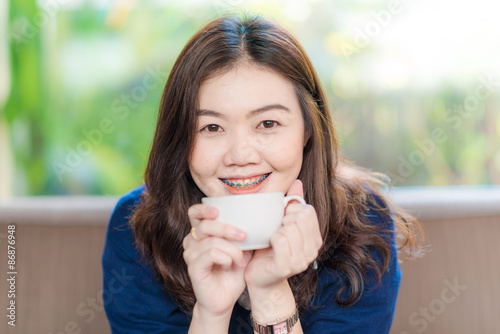 Young Business asian smiling woman Having a Coffee Break.  Close