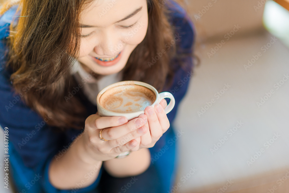Happy asian smiling female student drinking coffee Happy asian smiling female student drinking coffee