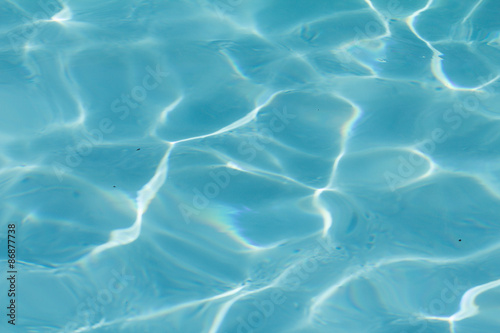 Fototapeta Naklejka Na Ścianę i Meble -  Blue pool water with sun reflections