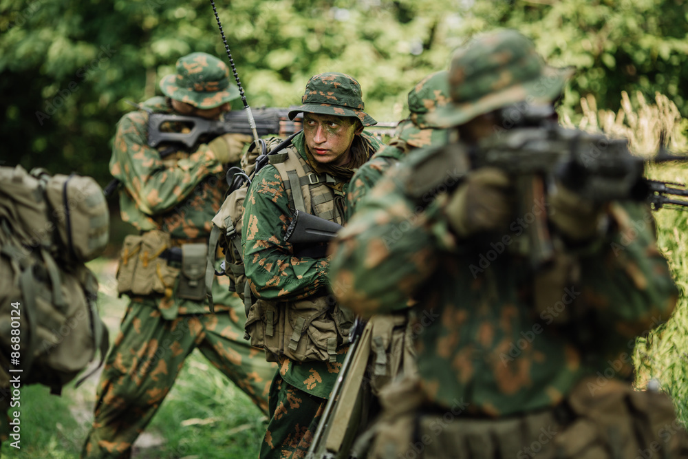 Group of soldiers special forces during the raid in the forest Group of soldiers special forces during the raid in the forest