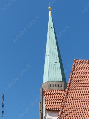 Kirchturmspitze der Altstädter Nicolaikirche mit Grünspan vor blauem Himmel im Sonnenschein in der Altstadt von Bielefeld im Teutoburger Wald in Ostwestfalen-Lippe photo