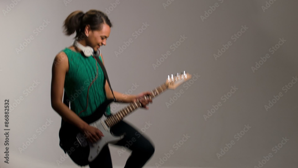 lovely woman plays on guitar and listens to music