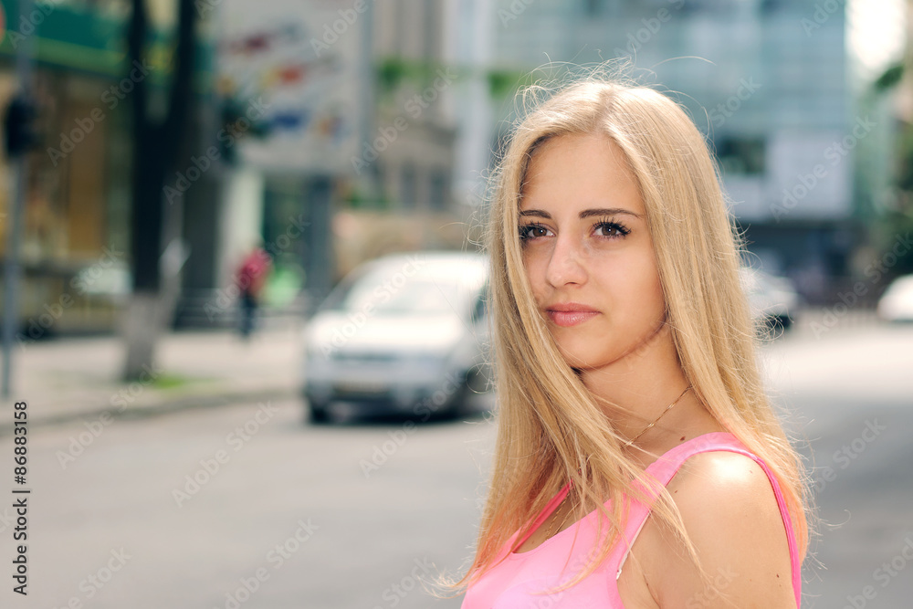 Blonde girl goes through the city