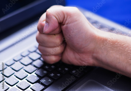 Hand Fist On The Keyboard Of Laptop