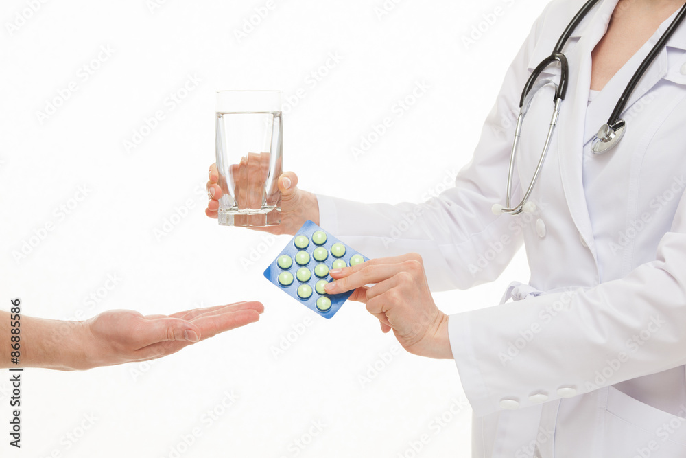 Doctor proposing a glass of water and tablets for patient Doctor proposing a glass of water and tablets for patient